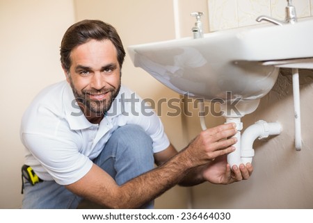 Plumber fixing the sink in a bathroom in a new house