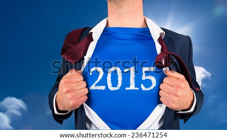 Businessman opening his shirt superhero style against bright blue sky with clouds