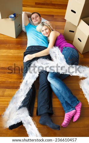 Cute couple sleeping on the floor against house outline in clouds