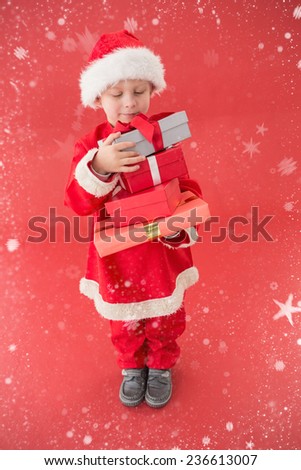 Cute little boy in santa costume against snow falling