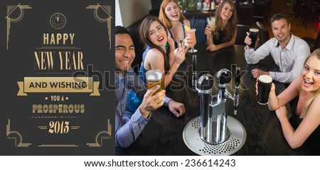 Laughing friends raising their glasses up against art deco new year greeting