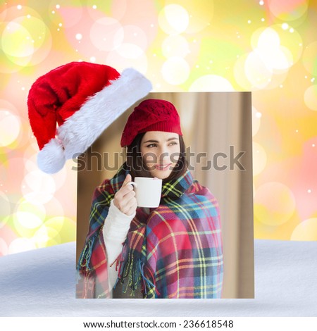 Brunette with cover holding mug and thinking against girly pink and yellow pattern