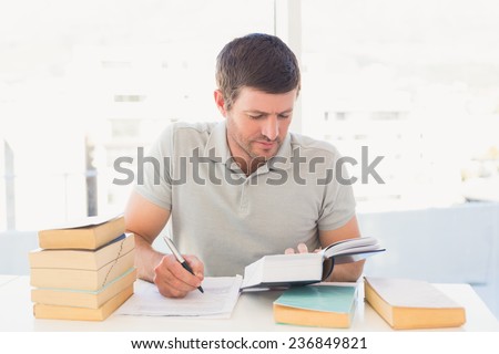 Casual businessman studying at his desk in his office