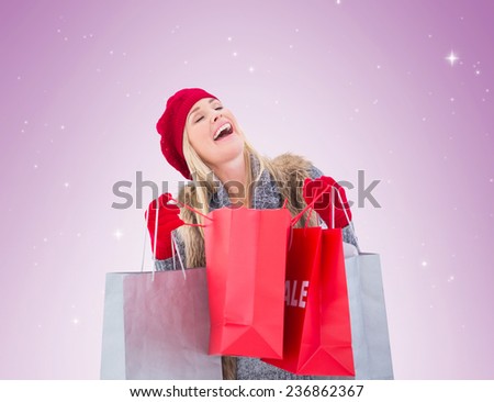Blonde in winter clothes with shopping bags on vignette background