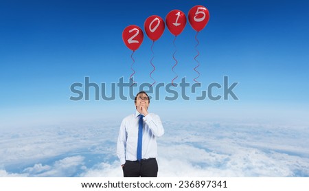 Thinking businessman touching his chin against blue sky over white clouds