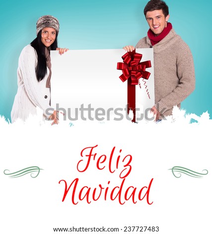 Composite image of young couple holding a poster against Christmas greeting card