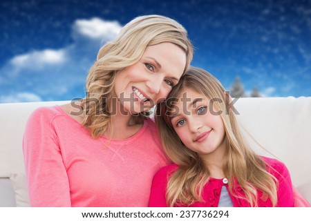 Mother and daughter against composite image of fir trees in snowy landscape