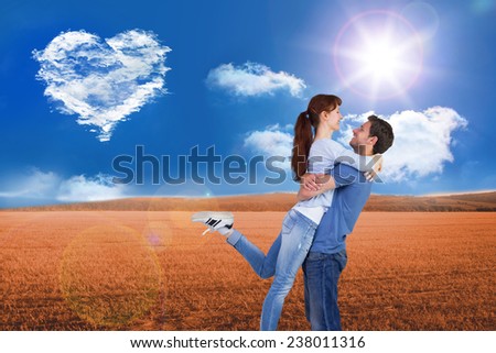 Couple hugging each other against cloud heart