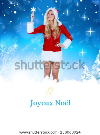 pretty girl in santa outfit holding hand up against tree spiral