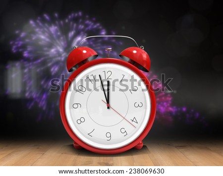 Alarm clock counting down to twelve against wooden planks