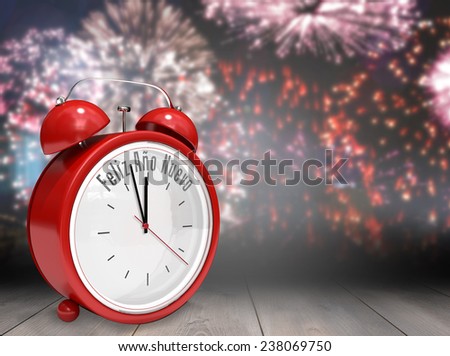 Feliz ano nuevo in red alarm clock against wooden planks