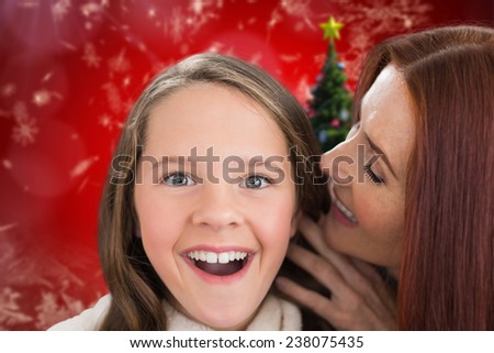 Mother and daughter telling secrets against christmas tree