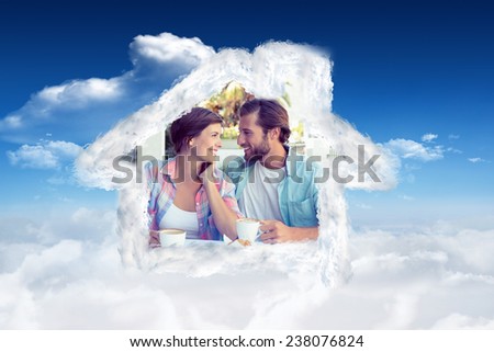 Happy couple enjoying coffee together against bright blue sky with clouds