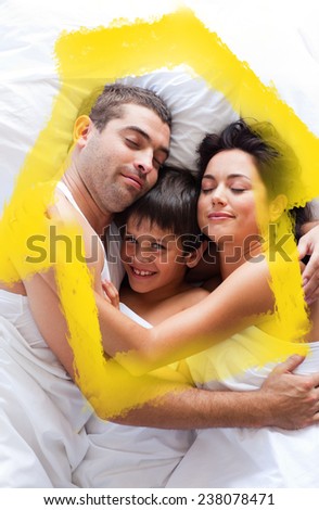 Happy family lying in bed against house outline in clouds