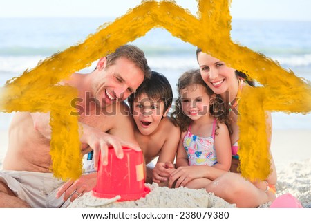 Family at the beach against house outline in clouds