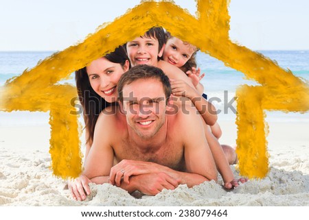 Family on the beach against house outline in clouds