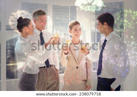 Smiling team of business people clinking their flutes of champagne against colourful fireworks exploding on black background