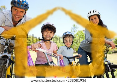 Family with their bikes against house outline in clouds