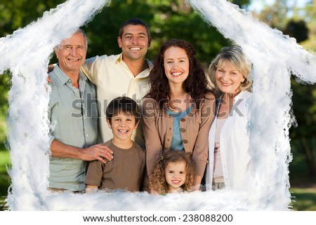 House outline in clouds against family looking at the camera in the park