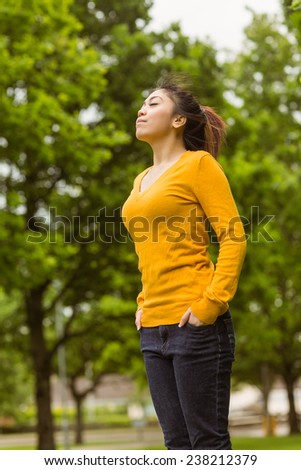 Low angle view of beautiful young woman with eyes closed in park