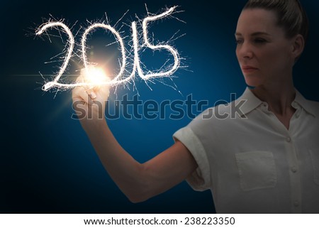Businesswoman touching spark against blue background with vignette