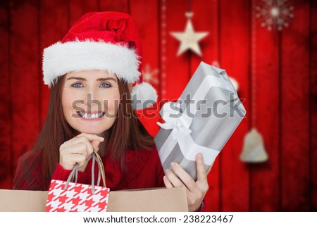 Woman with gifts against blurred christmas background