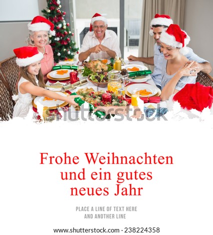 Cheerful family at dining table for christmas dinner against christmas greeting in german