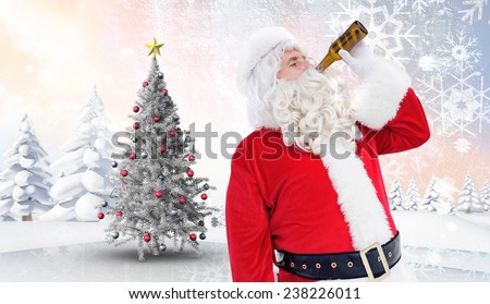 Father christmas drinking a beer against christmas tree in snowy landscape