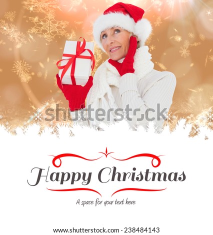 festive woman holding gift against border