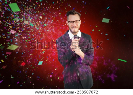 Hipster businessman giving a speech against colourful fireworks exploding on black background