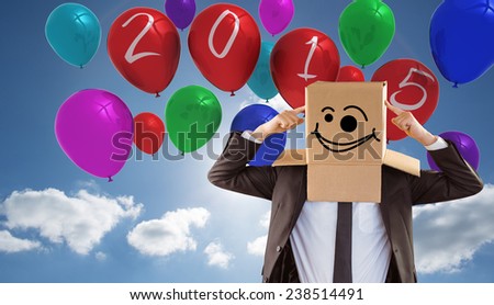 Anonymous businessman pointing to box against cloudy sky with sunshine