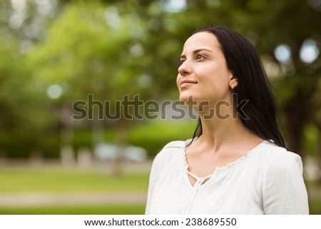 Portrait of a casual brunette smiling in the park