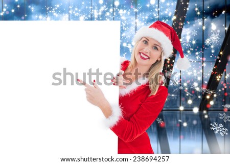 Festive blonde showing white card against glittering lights in room