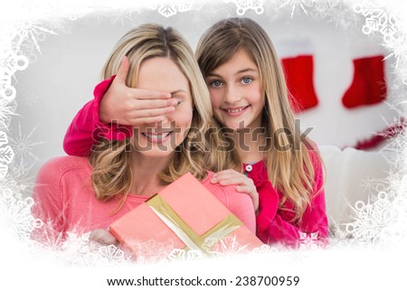 Little girl hiding gift from mother against frost frame