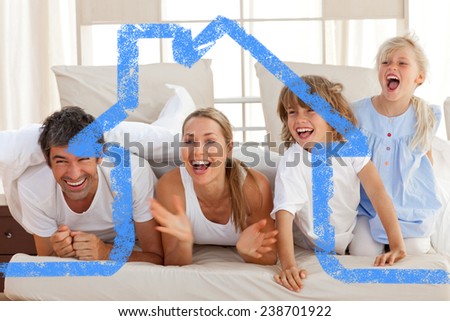 Laughing parents playing with their children against house outline