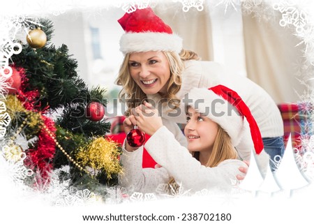 Festive mother and daughter decorating christmas tree against frost frame