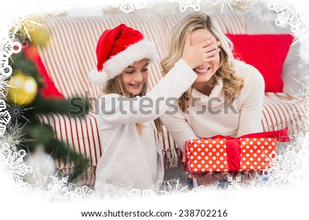 Festive mother and daughter with gift against frost frame