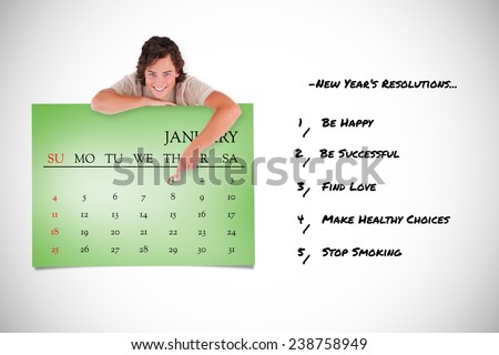 Smiling man pointing at a calendar against green card