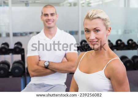 Portrait of a sporty young couple standing at fitness studio