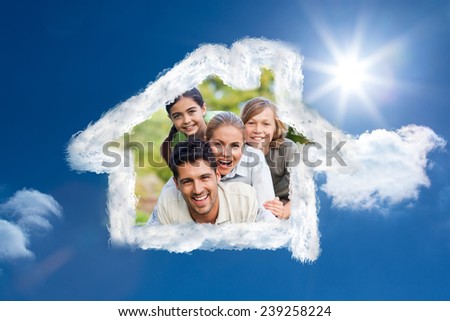 Happy family in the park against bright blue sky with clouds