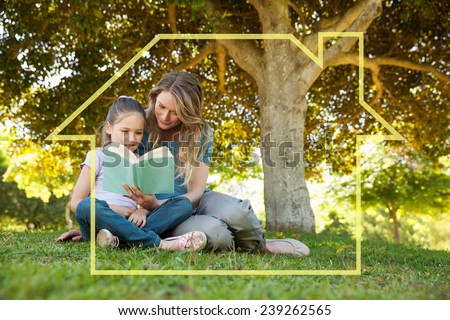 Mother and daughter reading a book at park against house outline