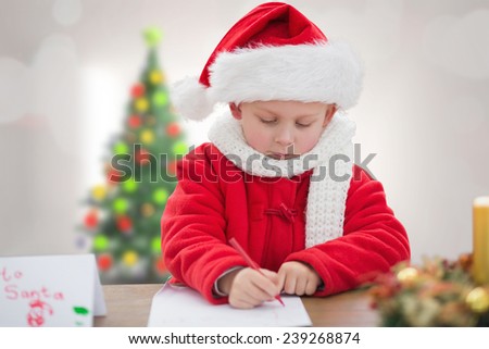 Cute boy drawing festive pictures against blurry christmas tree in room