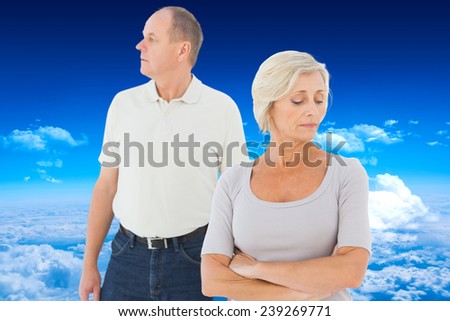 Older couple having an argument against mountain peak through clouds