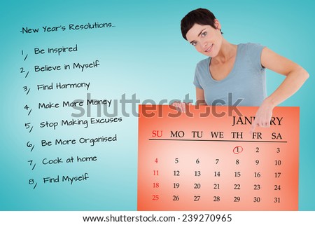 Smiling woman pointing at calendar on a panel against orange card