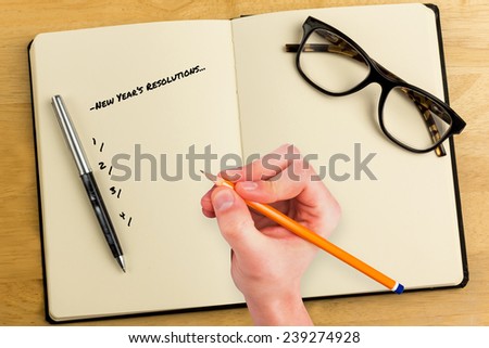 Composite image of new years resolutions against overhead of open notebook with pen and glasses