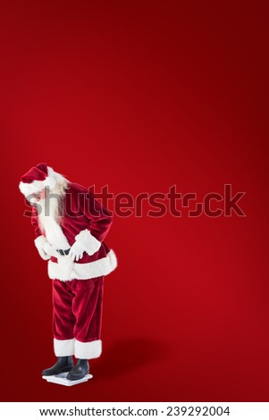 Santa looks down to personal scales against red background
