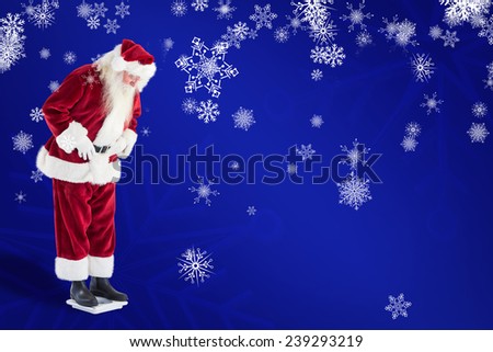 Santa looks down to personal scales against blue snowflake background