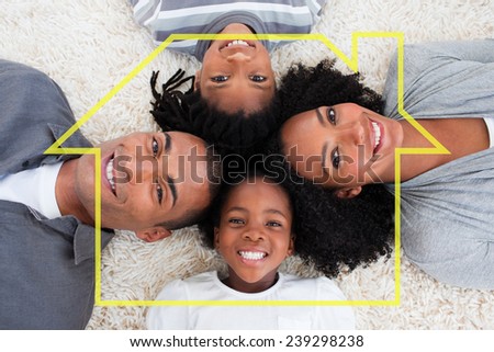 Family on floor with heads together against house outline