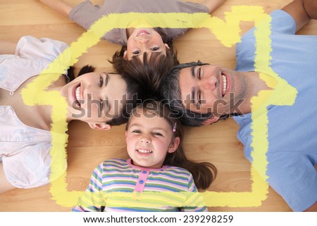 Lively family lying on the floor against house outline