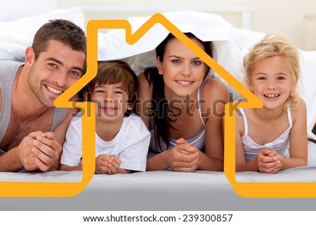 Family playing in parents bed against house outline
